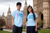 Boy and girl in Send My Sister to School tshirts outside the Houses of Parliament