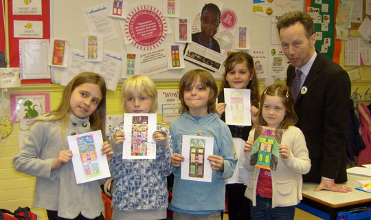 Children holding up colourful door artwork