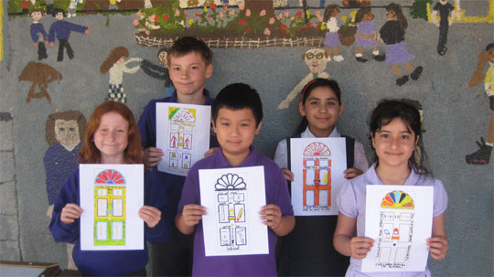 Children holding up colourful 'door' artwork