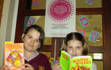 Two girls reading books.