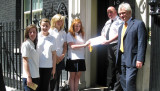 Girls present artwork on the doorstep of 10 Downing Street