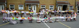 Schoolchildren holding up long colourful banner in school yard