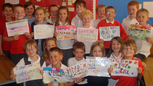 Children displaying paper scarf artwork