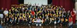 Large group of children holding up yellow cards