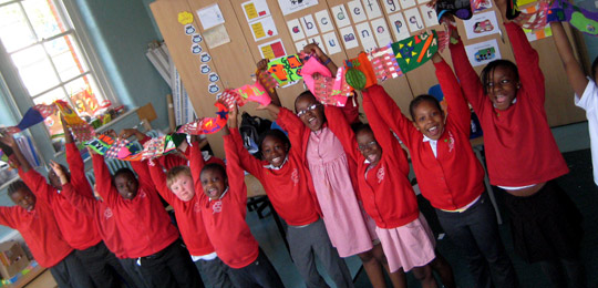 Children holding up supporter scarf