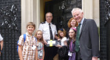 Adults and schoolchildren on the doorstep of 10 Downing Street