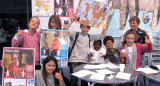 Children holding up posters and artwork