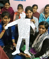 Indian girls holding up a puppet 'ideal teacher'